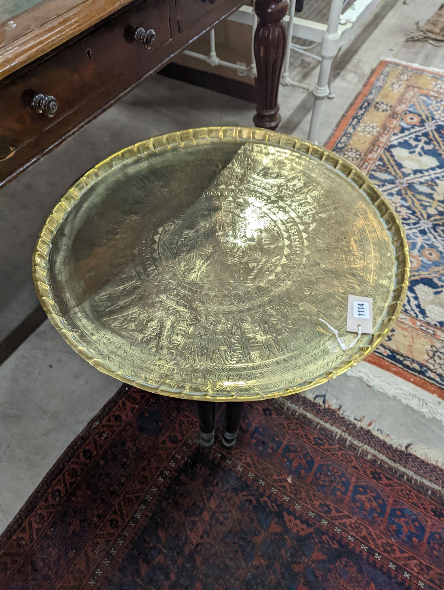 An Egyptian circular brass tray top occasional table, diameter 62cm, height 52cm